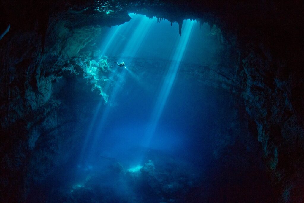 Photographer in cave blue